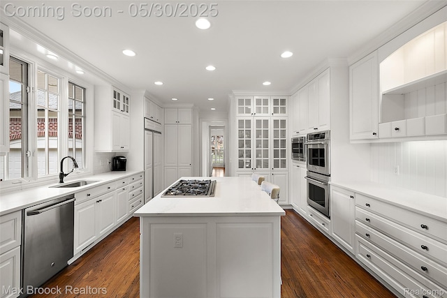 222 Arlington St, Birmingham, MI 48009 - kitchen with stainless steel appliances, a sink, white cabinetry, a center island, and dark wood-style floors