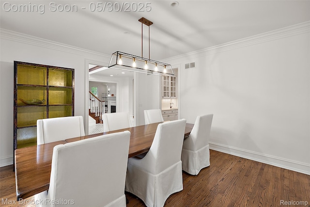 222 Arlington St, Birmingham, MI 48009 - dining area with crown molding, wood finished floors, baseboards, and stairs