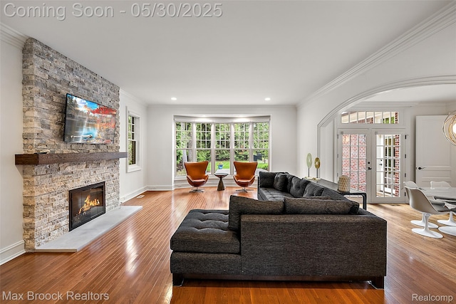 222 Arlington St, Birmingham, MI 48009 - living room with ornamental molding, wood finished floors, a stone fireplace, recessed lighting, and baseboards