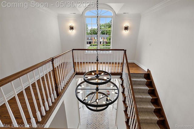 222 Arlington St, Birmingham, MI 48009 - staircase with ornamental molding, a chandelier, and wood finished floors