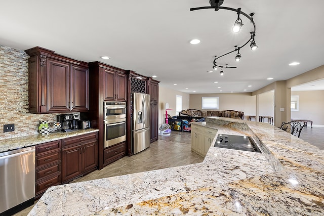 5060 Pratt Rd, Metamora, MI 48455 - kitchen with stainless steel appliances, open floor plan, backsplash, recessed lighting, and light stone countertops