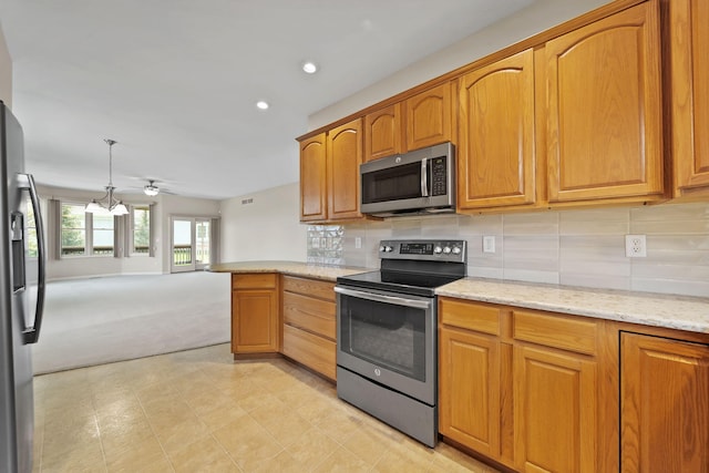 3605 Terrace Hills Ln, Jackson, MI 49203 - kitchen with stainless steel appliances, light carpet, light stone counters, recessed lighting, and decorative backsplash