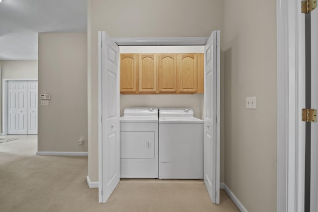 3605 Terrace Hills Ln, Jackson, MI 49203 - laundry room with separate washer and dryer, light colored carpet, cabinet space, and baseboards
