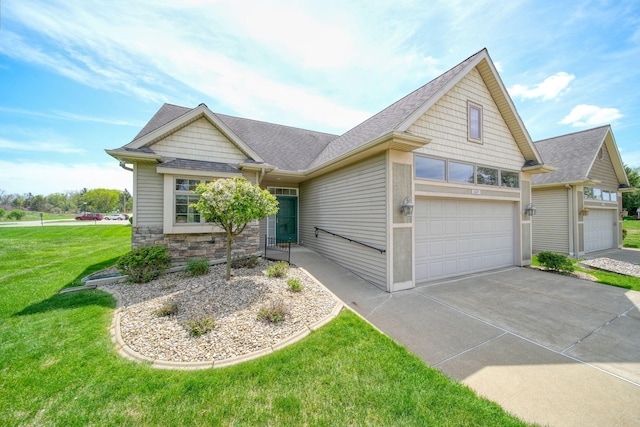 3605 Terrace Hills Ln, Jackson, MI 49203 - view of front facade featuring concrete driveway, a front yard, stone siding, and a shingled roof