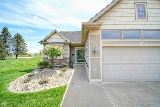 3605 Terrace Hills Ln, Jackson, MI 49203 - view of front of house featuring a front yard, driveway, and stone siding