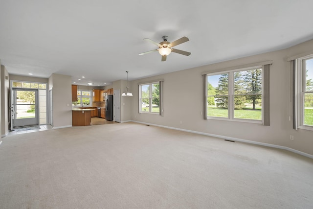 3605 Terrace Hills Ln, Jackson, MI 49203 - unfurnished living room featuring baseboards, a ceiling fan, light carpet, and recessed lighting