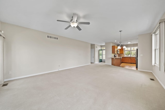 3605 Terrace Hills Ln, Jackson, MI 49203 - unfurnished living room featuring light colored carpet, ceiling fan, baseboards, and recessed lighting