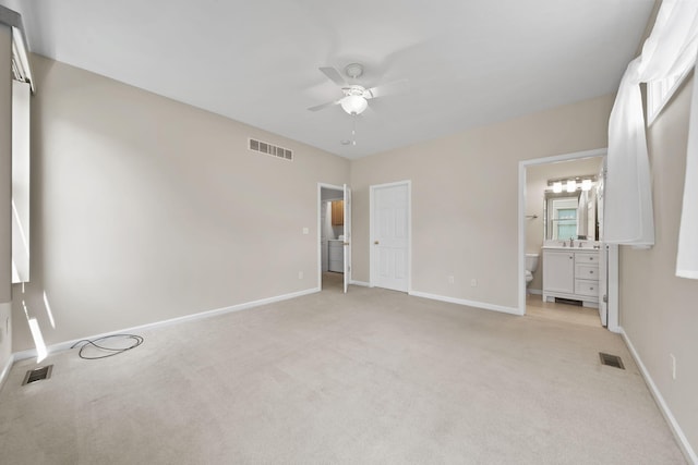 3605 Terrace Hills Ln, Jackson, MI 49203 - unfurnished bedroom with light carpet, baseboards, ensuite bathroom, a sink, and a ceiling fan