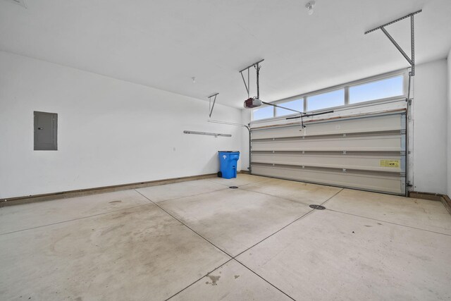 3605 Terrace Hills Ln, Jackson, MI 49203 - garage featuring electric panel, baseboards, and a garage door opener