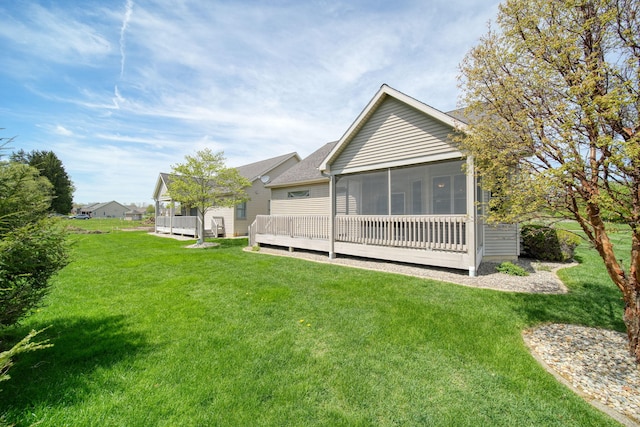 3605 Terrace Hills Ln, Jackson, MI 49203 - back of property with a sunroom, a yard, a shingled roof, and a deck