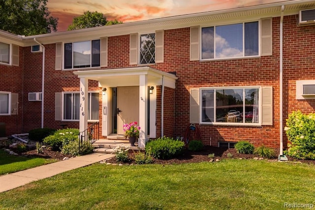 24111 Meridian Rd Unit 116, Grosse Ile, MI 48138 - view of front facade with brick siding and a yard