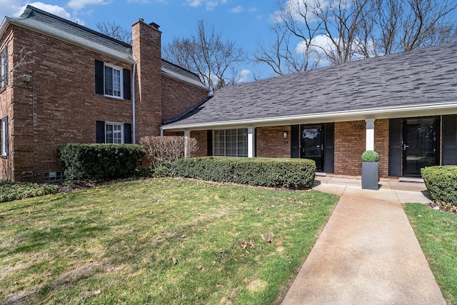 1750 Tiverton Rd Unit 28, Bloomfield Hills, MI 48304 - view of front of house featuring brick siding, a front yard, and a chimney