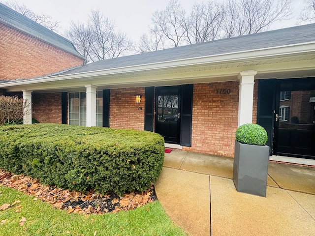 1750 Tiverton Rd Unit 28, Bloomfield Hills, MI 48304 - doorway to property with brick siding and covered porch