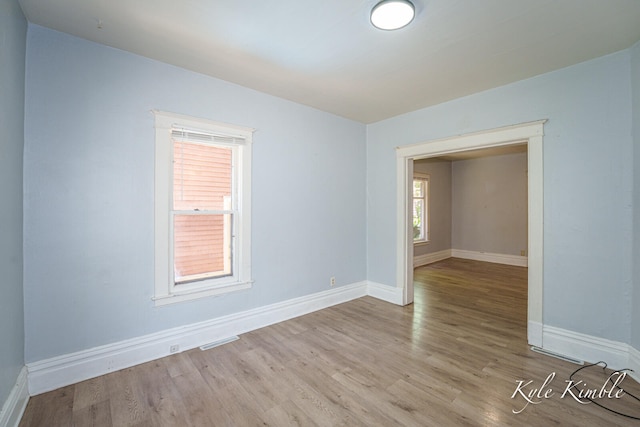 empty room featuring wood finished floors and baseboards
