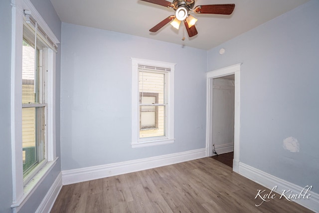 unfurnished room with ceiling fan, wood finished floors, and baseboards