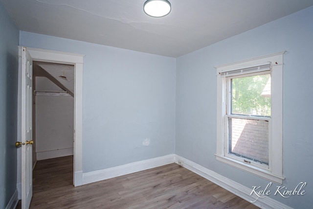 unfurnished bedroom with wood finished floors and baseboards
