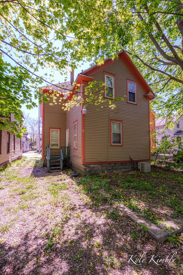 back of house featuring a chimney