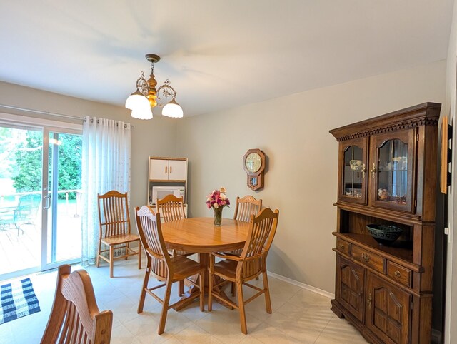 dining space with a chandelier and baseboards
