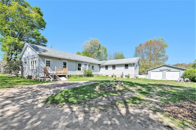 25161 59 1/2 St, Bangor, MI 49013 - view of front of property with a garage, a wooden deck, an outbuilding, and a front lawn