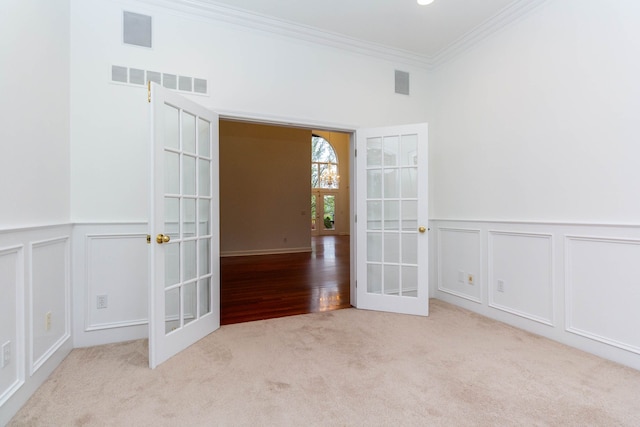 685 Dornoch Dr, Ann Arbor, MI 48103 - carpeted spare room with french doors, crown molding, a decorative wall, and wainscoting
