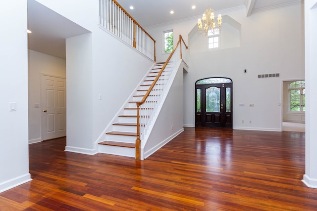 685 Dornoch Dr, Ann Arbor, MI 48103 - foyer entrance featuring stairs, a chandelier, wood finished floors, healthy amount of natural light, and a high ceiling