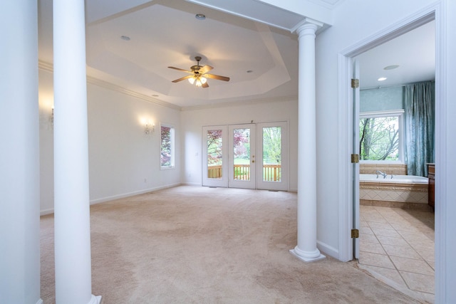 685 Dornoch Dr, Ann Arbor, MI 48103 - unfurnished living room with decorative columns, carpet, a ceiling fan, crown molding, and a tray ceiling