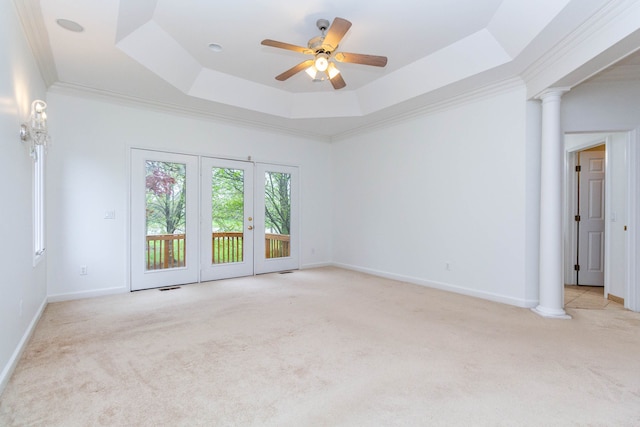 685 Dornoch Dr, Ann Arbor, MI 48103 - empty room featuring light colored carpet, ornate columns, a tray ceiling, ceiling fan, and baseboards