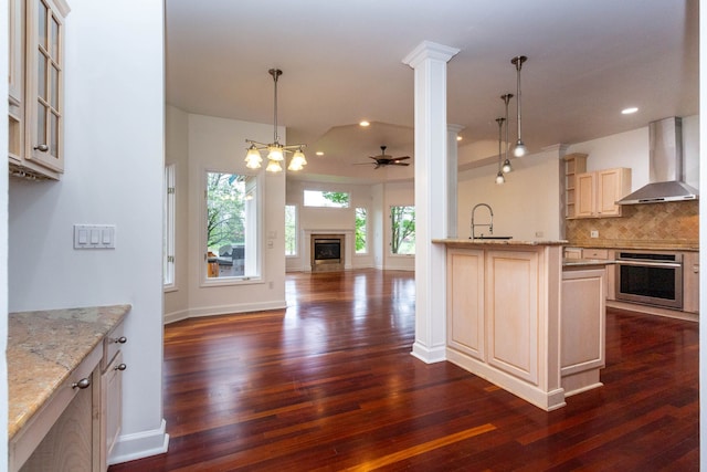 685 Dornoch Dr, Ann Arbor, MI 48103 - kitchen featuring wall chimney exhaust hood, oven, dark wood-type flooring, decorative backsplash, and a ceiling fan