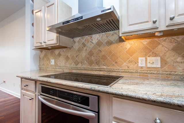 685 Dornoch Dr, Ann Arbor, MI 48103 - kitchen with wall chimney range hood, oven, baseboards, dark wood-type flooring, and black electric cooktop