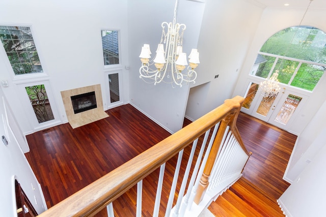 685 Dornoch Dr, Ann Arbor, MI 48103 - stairway with a chandelier, wood finished floors, healthy amount of natural light, a high ceiling, and crown molding