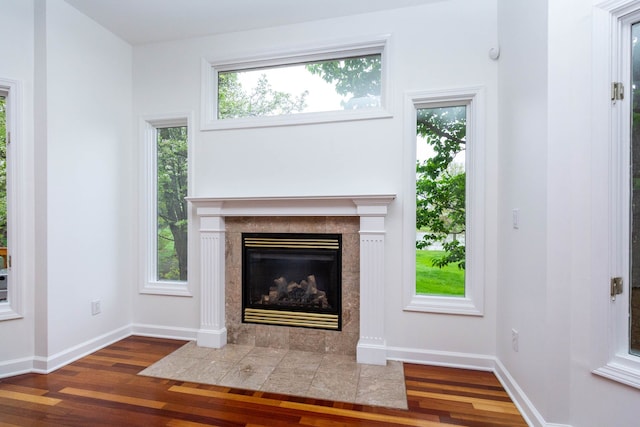 685 Dornoch Dr, Ann Arbor, MI 48103 - unfurnished living room featuring wood finished floors, a fireplace, healthy amount of natural light, and baseboards