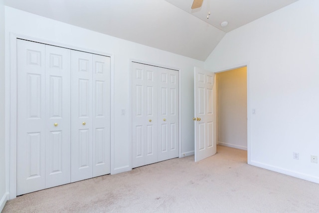 685 Dornoch Dr, Ann Arbor, MI 48103 - unfurnished bedroom with carpet, multiple closets, lofted ceiling, baseboards, and ceiling fan