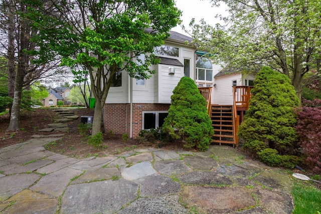 685 Dornoch Dr, Ann Arbor, MI 48103 - back of property with stairway and a wooden deck