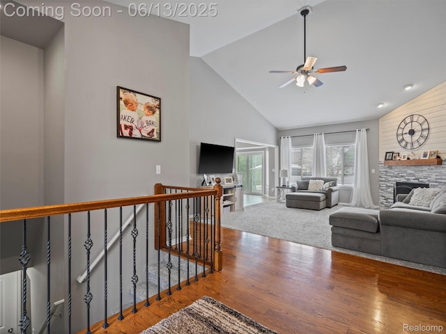45877 Andrew Dr, Macomb, MI 48044 - living room featuring high vaulted ceiling, a stone fireplace, a ceiling fan, and wood finished floors