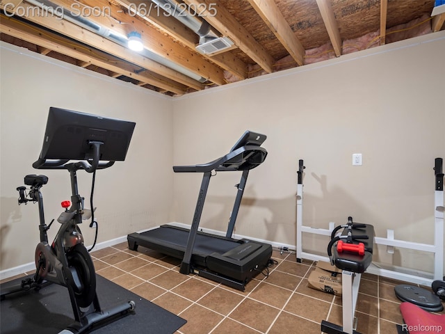 45877 Andrew Dr, Macomb, MI 48044 - workout area featuring dark tile patterned flooring and baseboards