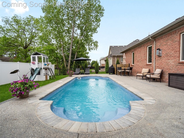 45877 Andrew Dr, Macomb, MI 48044 - view of pool featuring a playground, a patio, a fenced backyard, and outdoor dining space