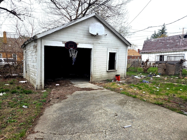 19183 Yonka St, Detroit, MI 48234 - view of outbuilding featuring fence, driveway, and an outdoor structure