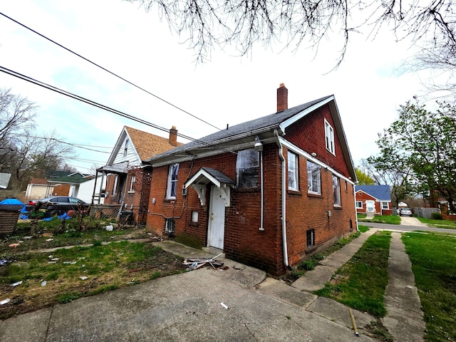 19183 Yonka St, Detroit, MI 48234 - view of front of house with a chimney and brick siding