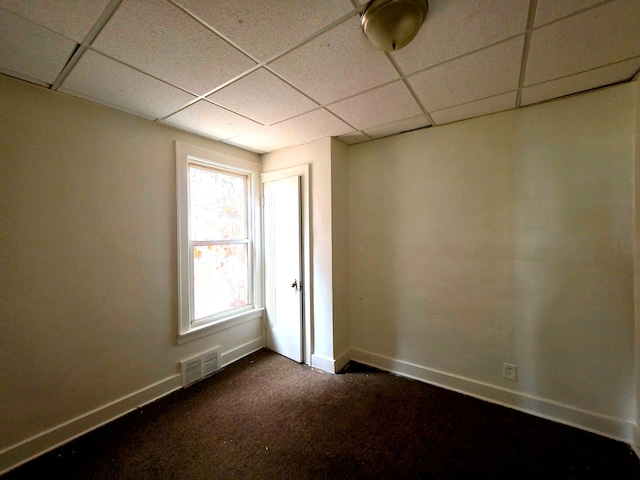 19183 Yonka St, Detroit, MI 48234 - empty room with a paneled ceiling, baseboards, and dark carpet