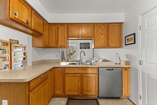 6809 Kingsley St, Dearborn, MI 48126 - kitchen with stainless steel dishwasher, a sink, light countertops, a peninsula, and light tile patterned floors