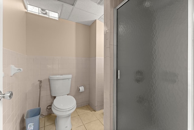 6809 Kingsley St, Dearborn, MI 48126 - bathroom with a stall shower, tile walls, tile patterned floors, toilet, and wainscoting
