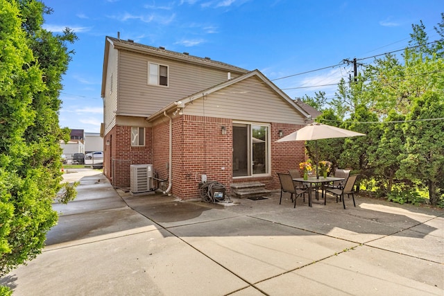 6809 Kingsley St, Dearborn, MI 48126 - rear view of house with entry steps, brick siding, cooling unit, and a patio area