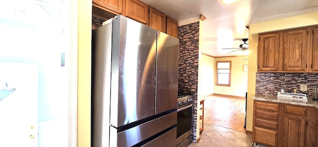 9608 Mercedes, Redford, MI 48239 - kitchen with appliances with stainless steel finishes, brown cabinetry, backsplash, ceiling fan, and ornamental molding