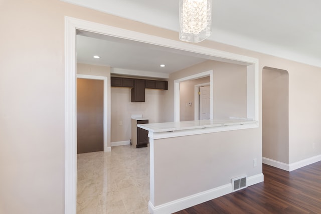 11580 Findlay St, Detroit, MI 48205 - kitchen with light countertops, a peninsula, dark brown cabinets, baseboards, and recessed lighting