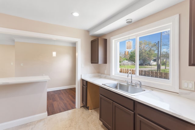 11580 Findlay St, Detroit, MI 48205 - kitchen featuring a sink, light countertops, pendant lighting, recessed lighting, and baseboards
