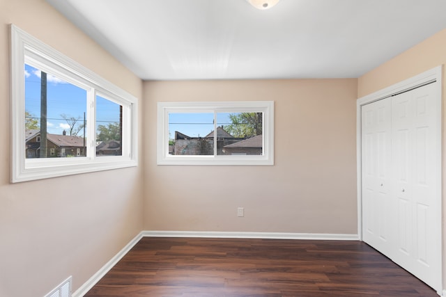 11580 Findlay St, Detroit, MI 48205 - unfurnished bedroom with dark wood-type flooring, baseboards, and a closet