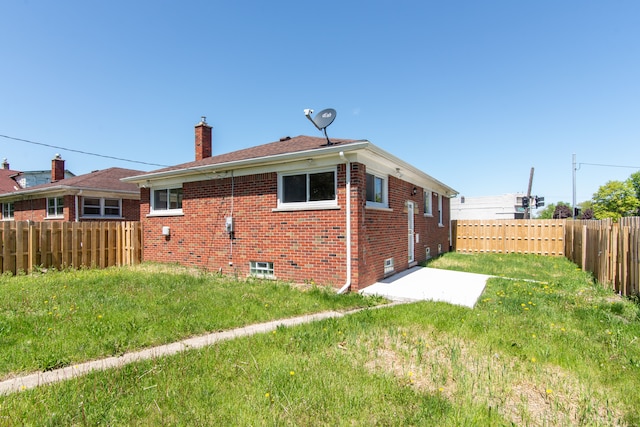 11580 Findlay St, Detroit, MI 48205 - back of property featuring a chimney, brick siding, and a patio area