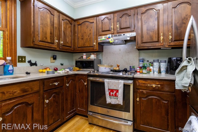 3168 Farmbrook Ln, Metamora, MI 48455 - kitchen featuring stainless steel appliances, under cabinet range hood, ornamental molding, light countertops, and light wood-style floors