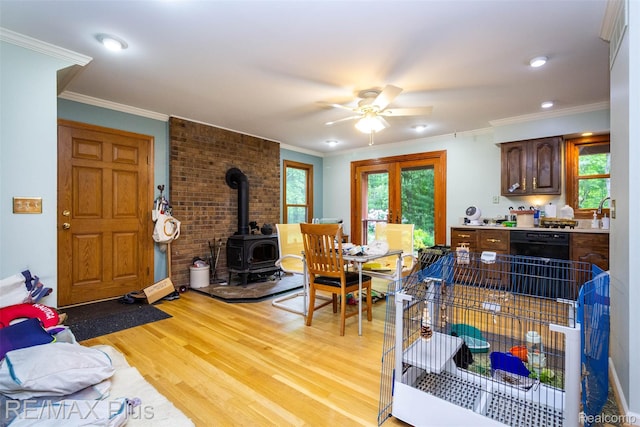 3168 Farmbrook Ln, Metamora, MI 48455 - living area featuring a wood stove, light wood-type flooring, a ceiling fan, crown molding, and recessed lighting