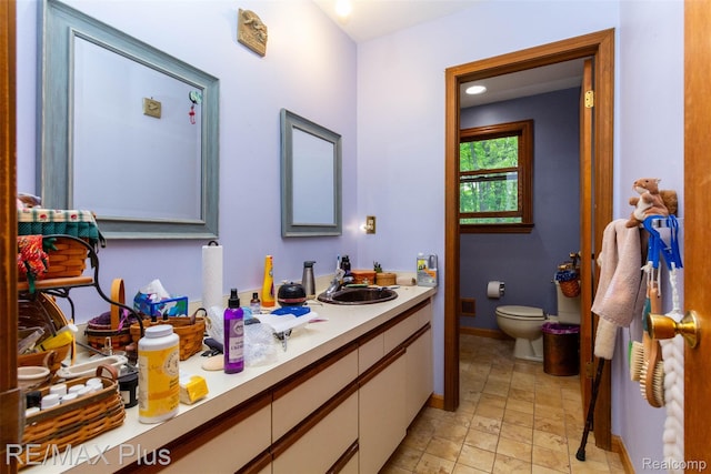 3168 Farmbrook Ln, Metamora, MI 48455 - bathroom featuring toilet, baseboards, and vanity